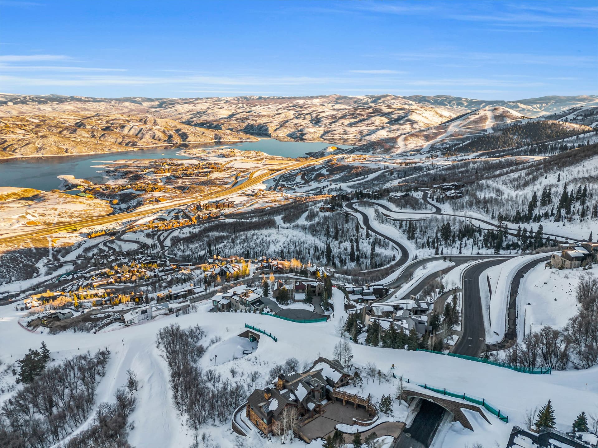 A distant, aerial view of the property, with roads winding through the snow all around it.