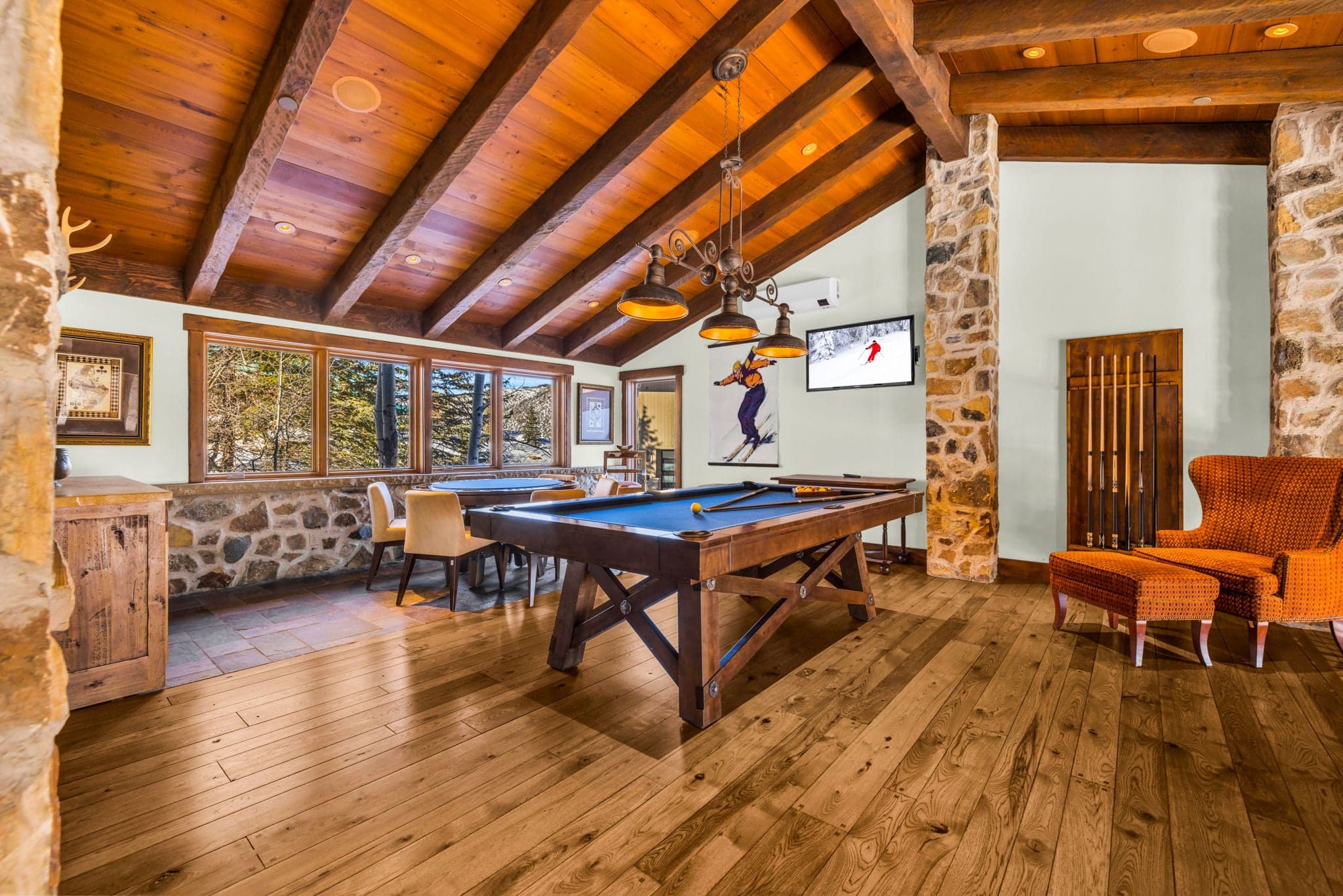 Game room with pool table, vaulted wood ceiling, and mounted TV.