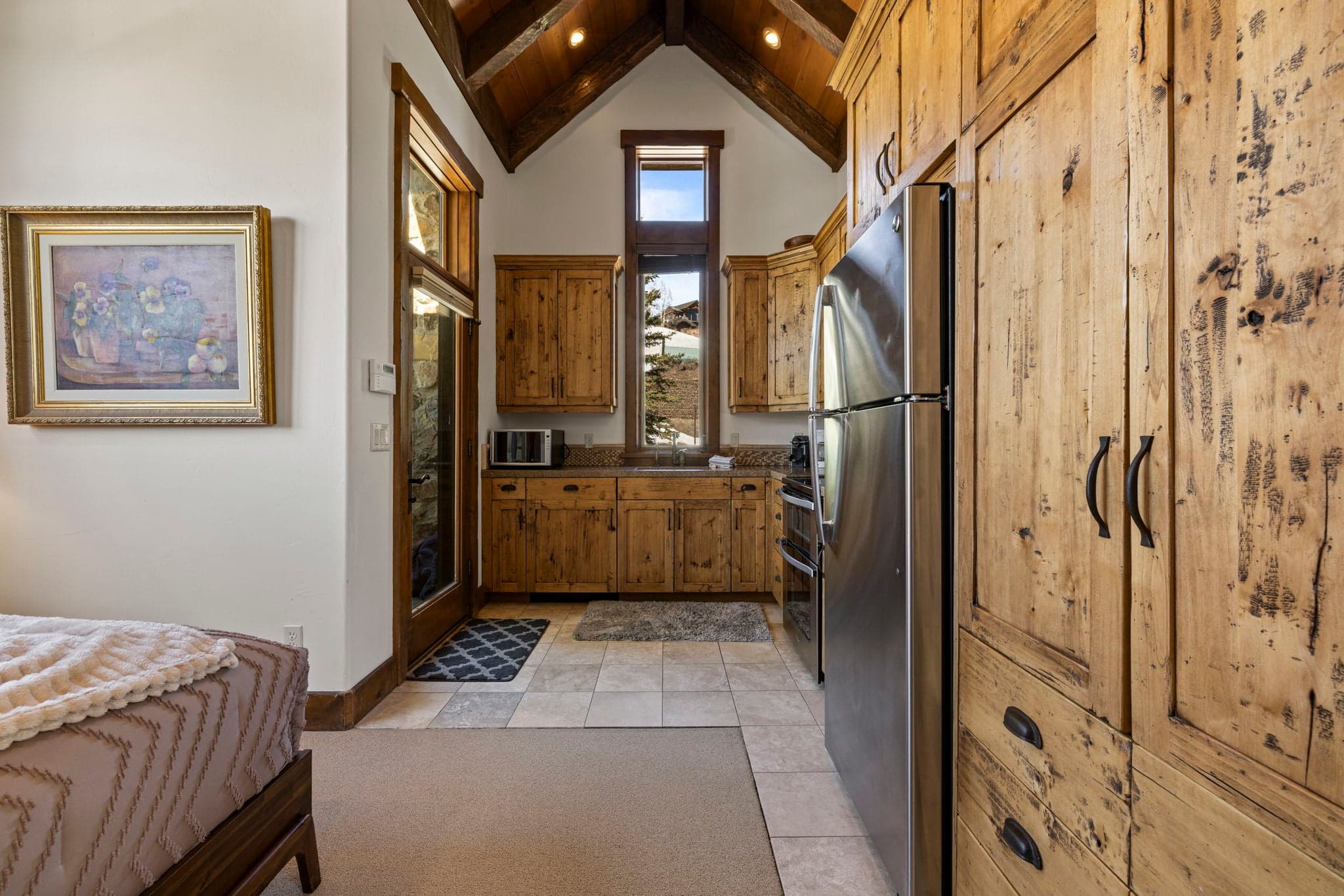 Loft suite kitchenette with wood cabinets, sink, and microwave