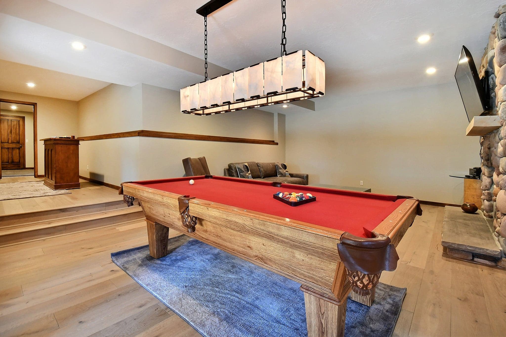 Large Game Room Featuring a Pool Table and Fireplace.