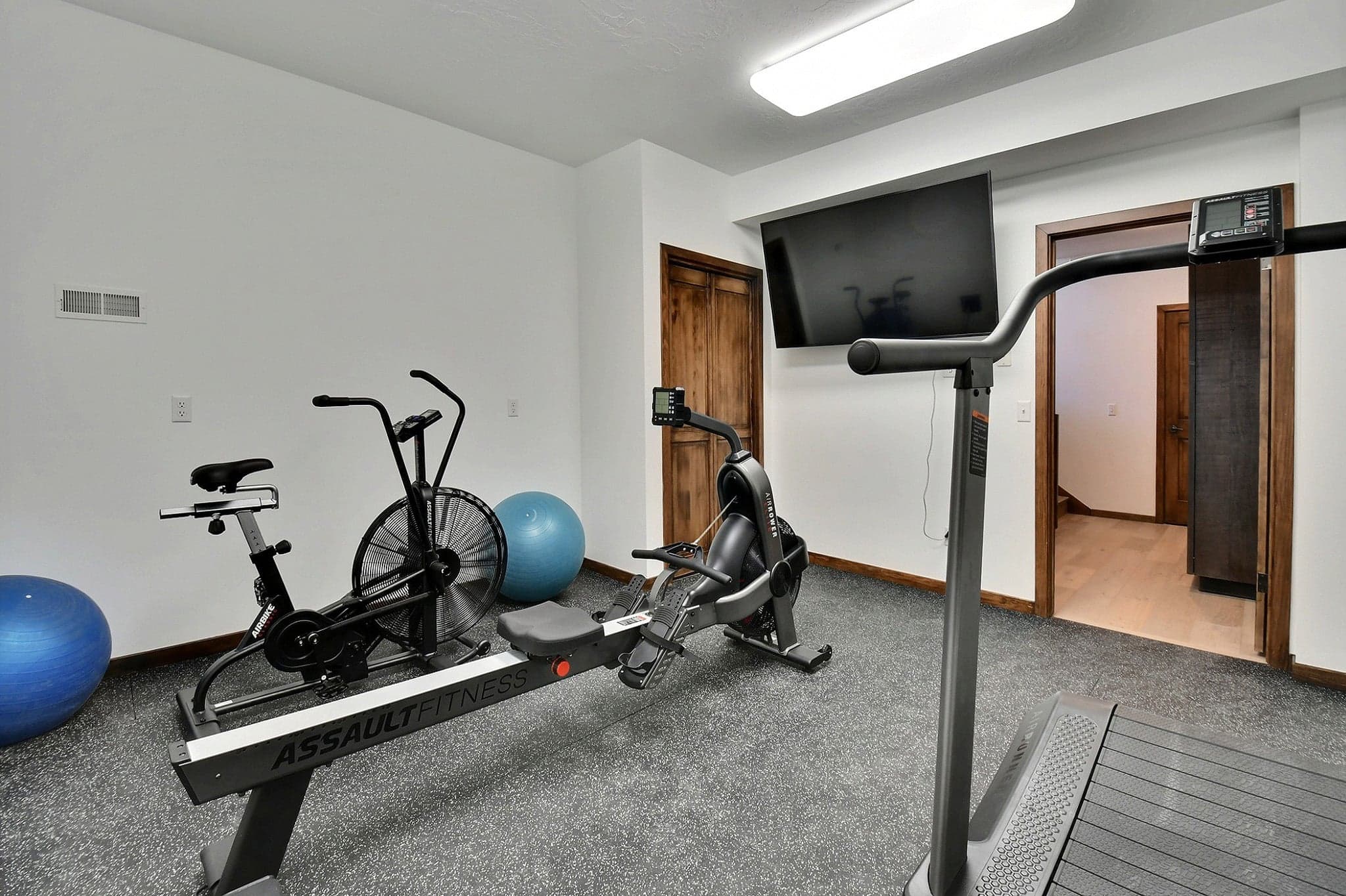 Private Exercise Room Featuring Several Machines.