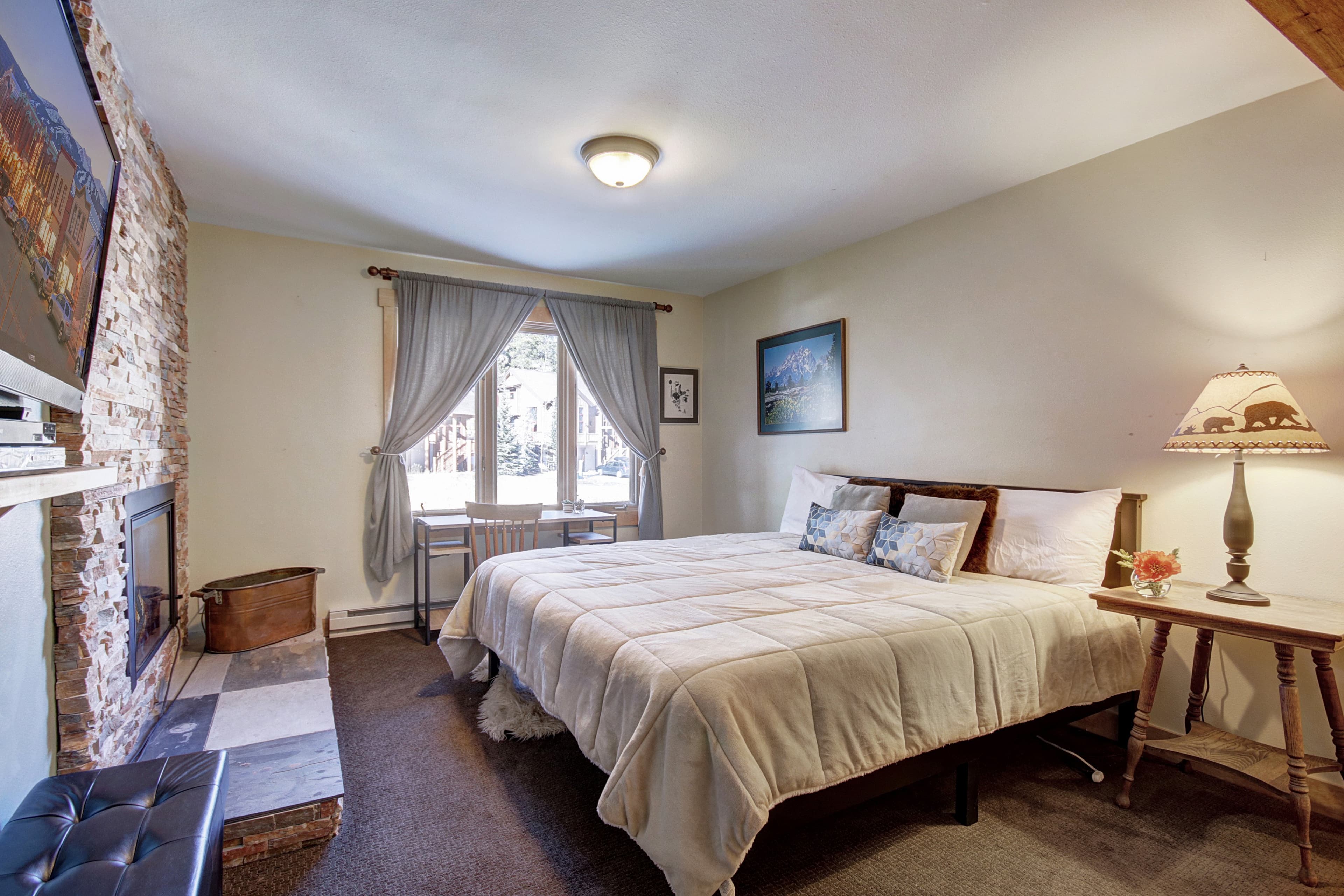 King-size bed located in the lower level bedroom - 4 O'Clock Lodge D26 Breckenridge Vacation Rental