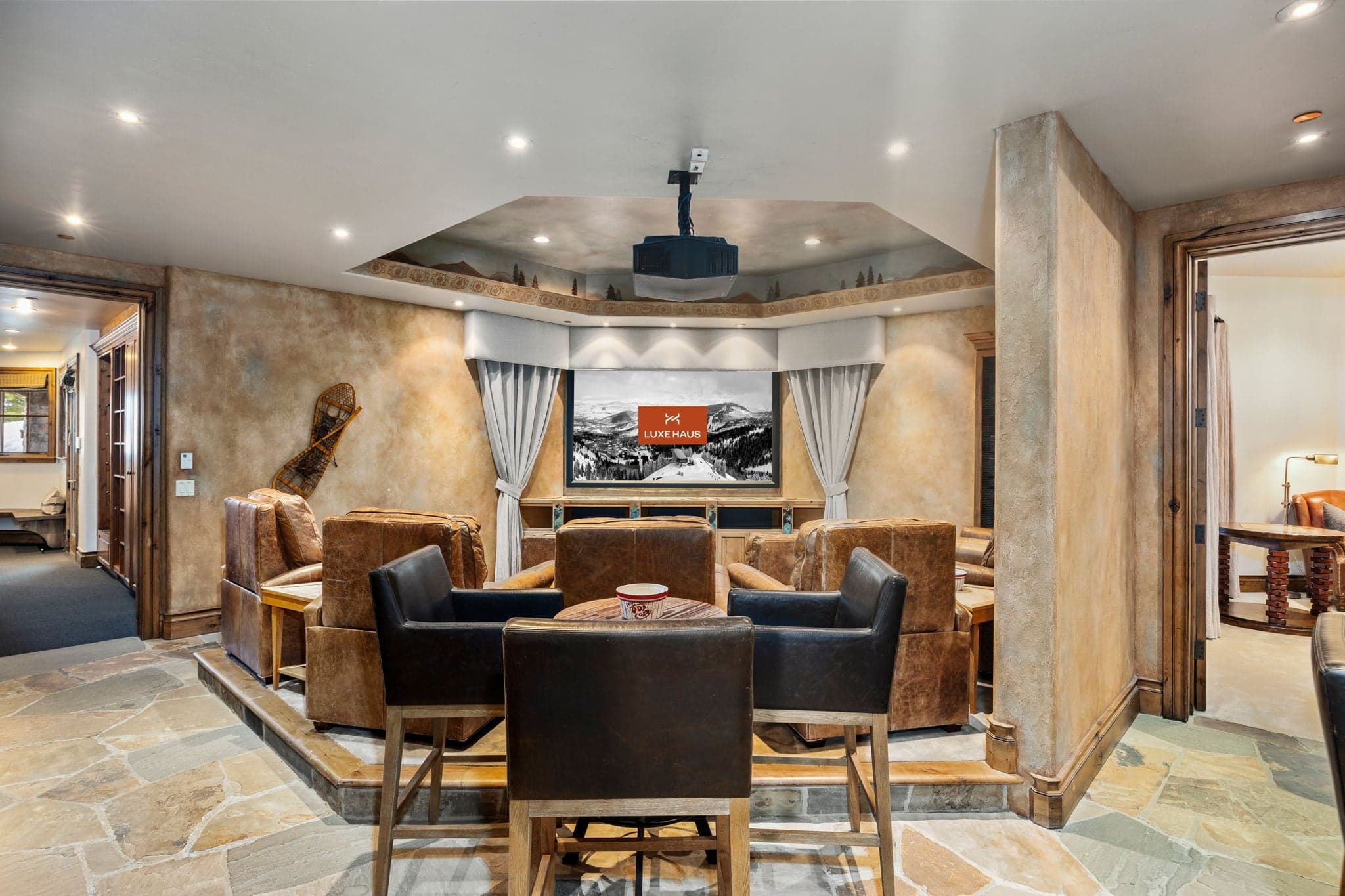 game table with chairs behind the home theater
