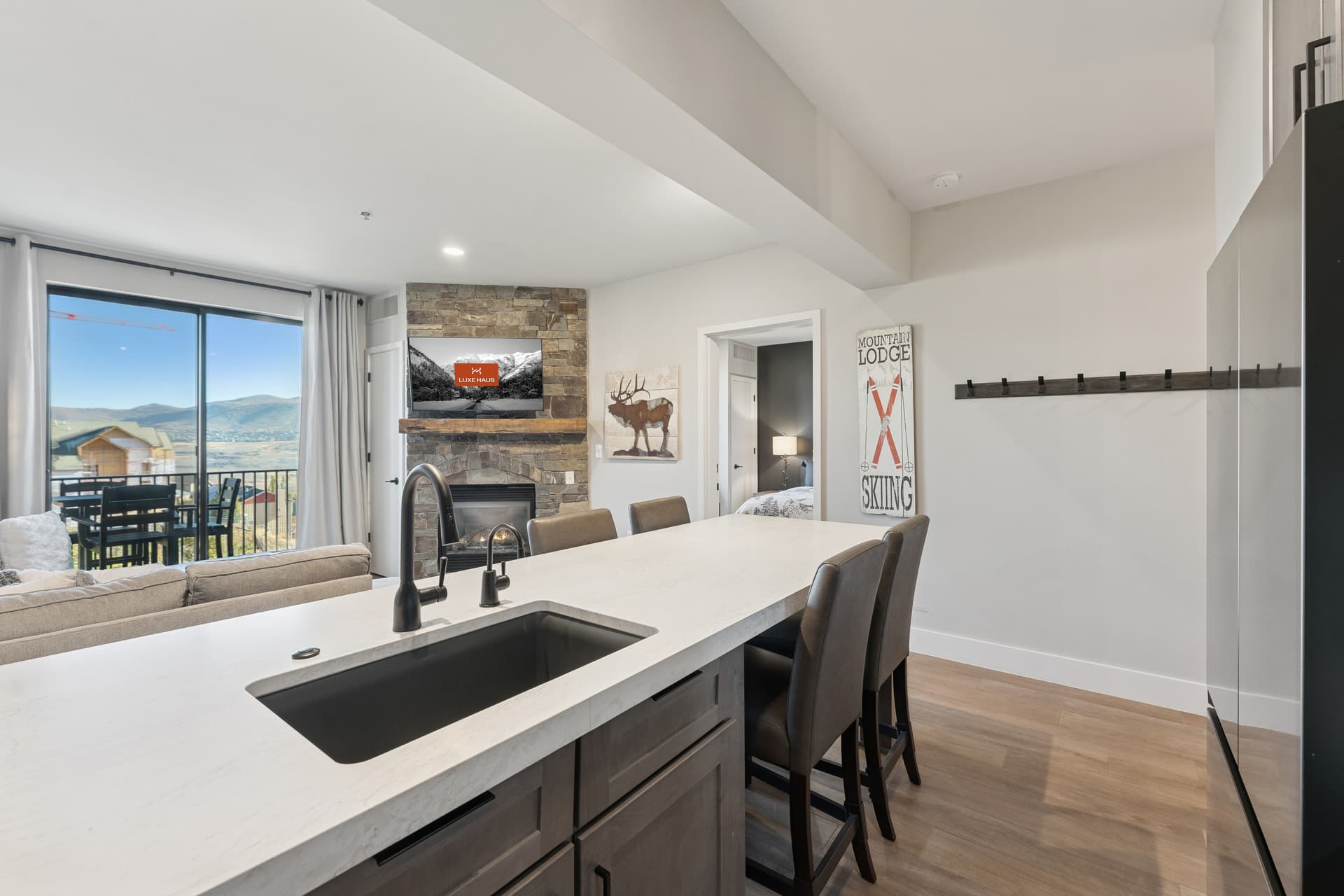 Elegant condo kitchen and dining area in Park City featuring upscale finishes, pendant lighting, and a warm alpine aesthetic.