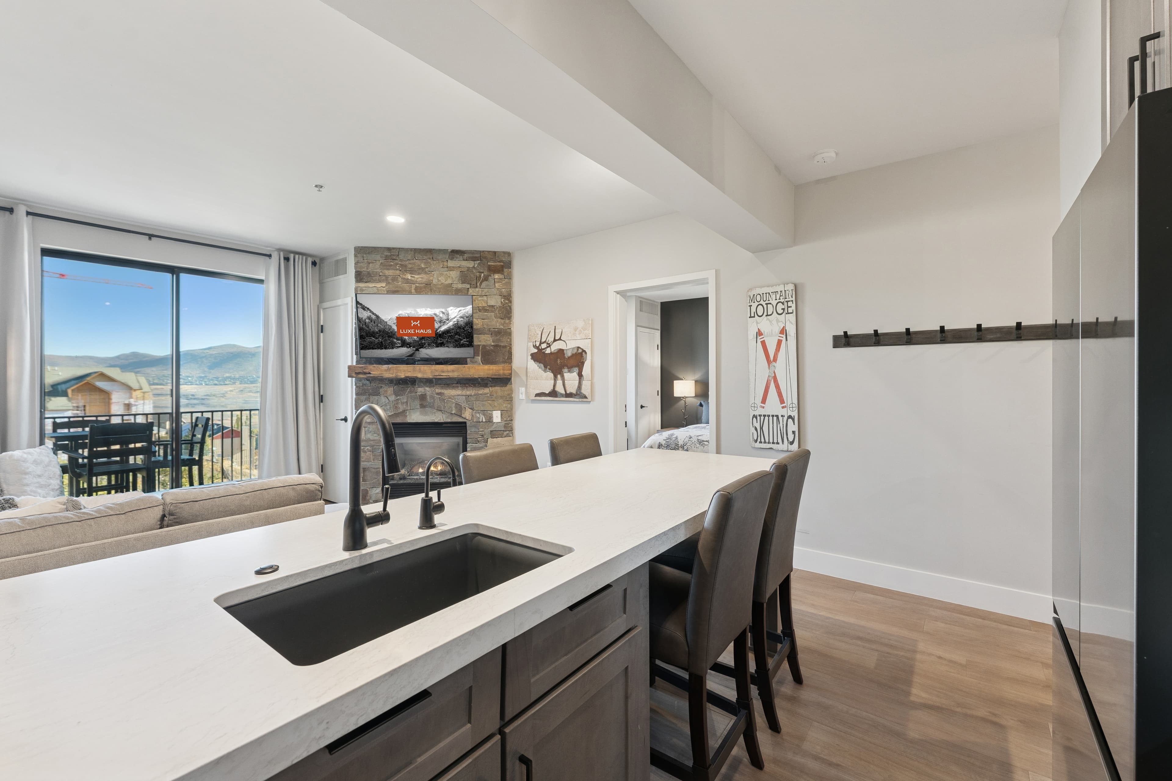 Elegant condo kitchen and dining area in Park City featuring upscale finishes, pendant lighting, and a warm alpine aesthetic.