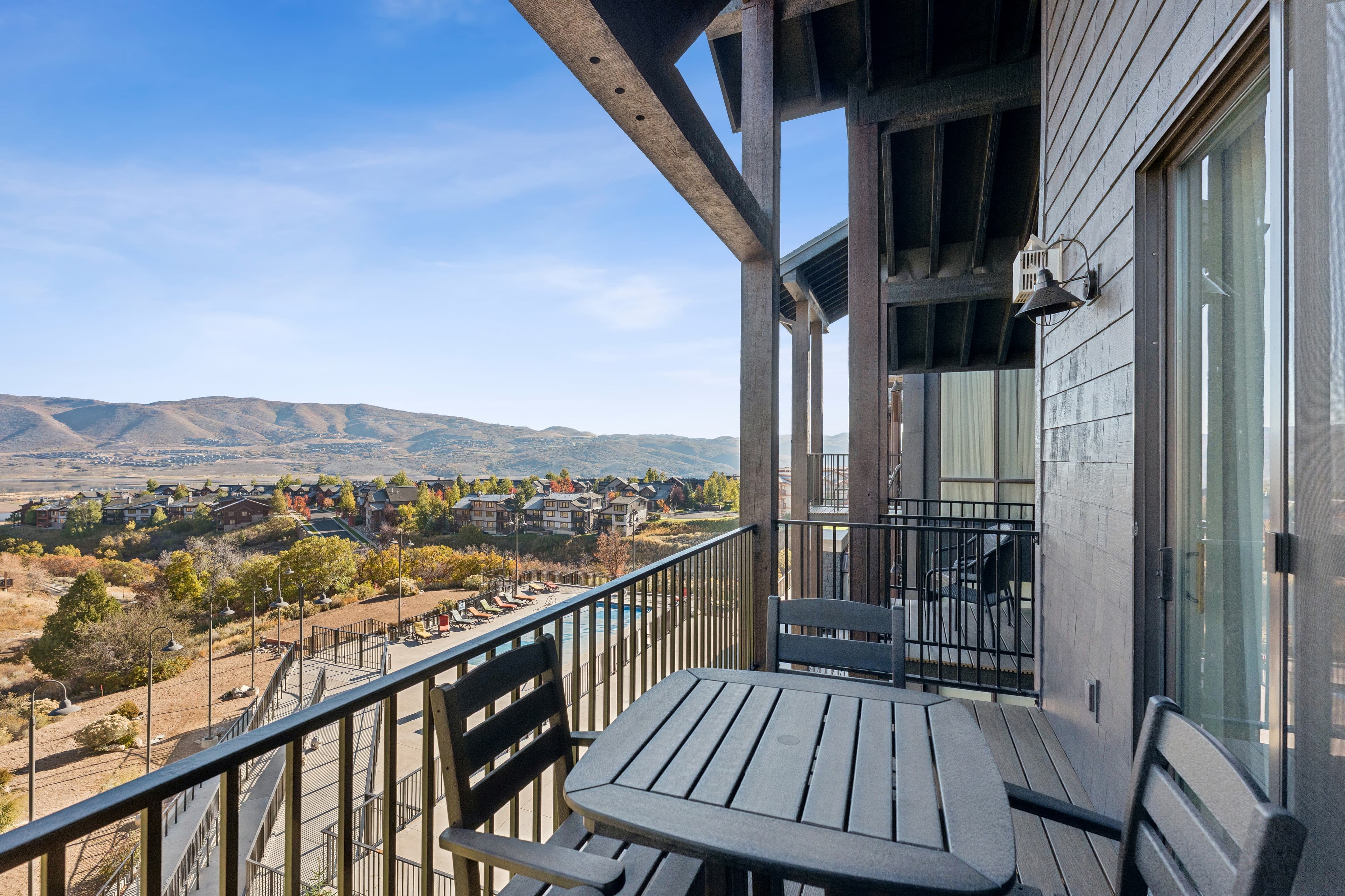 Private condo balcony with seating and panoramic views of Park City's mountain landscape.